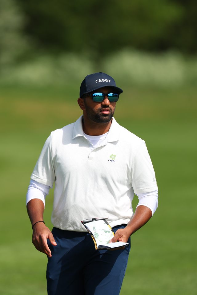 Yadhu Urs walking the course with his yardage book