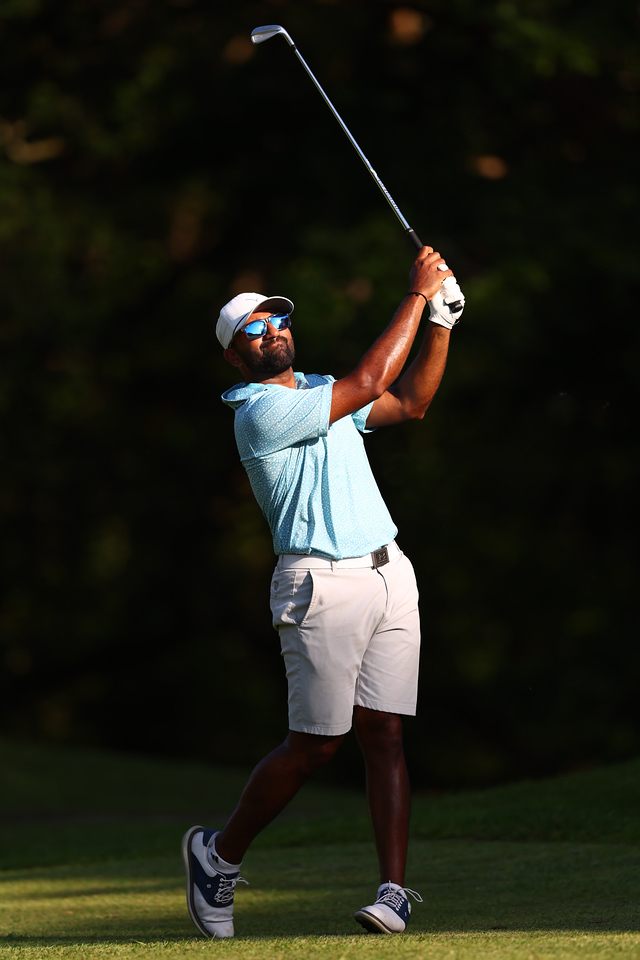 Yadhu Urs playing an iron shot in evening light
