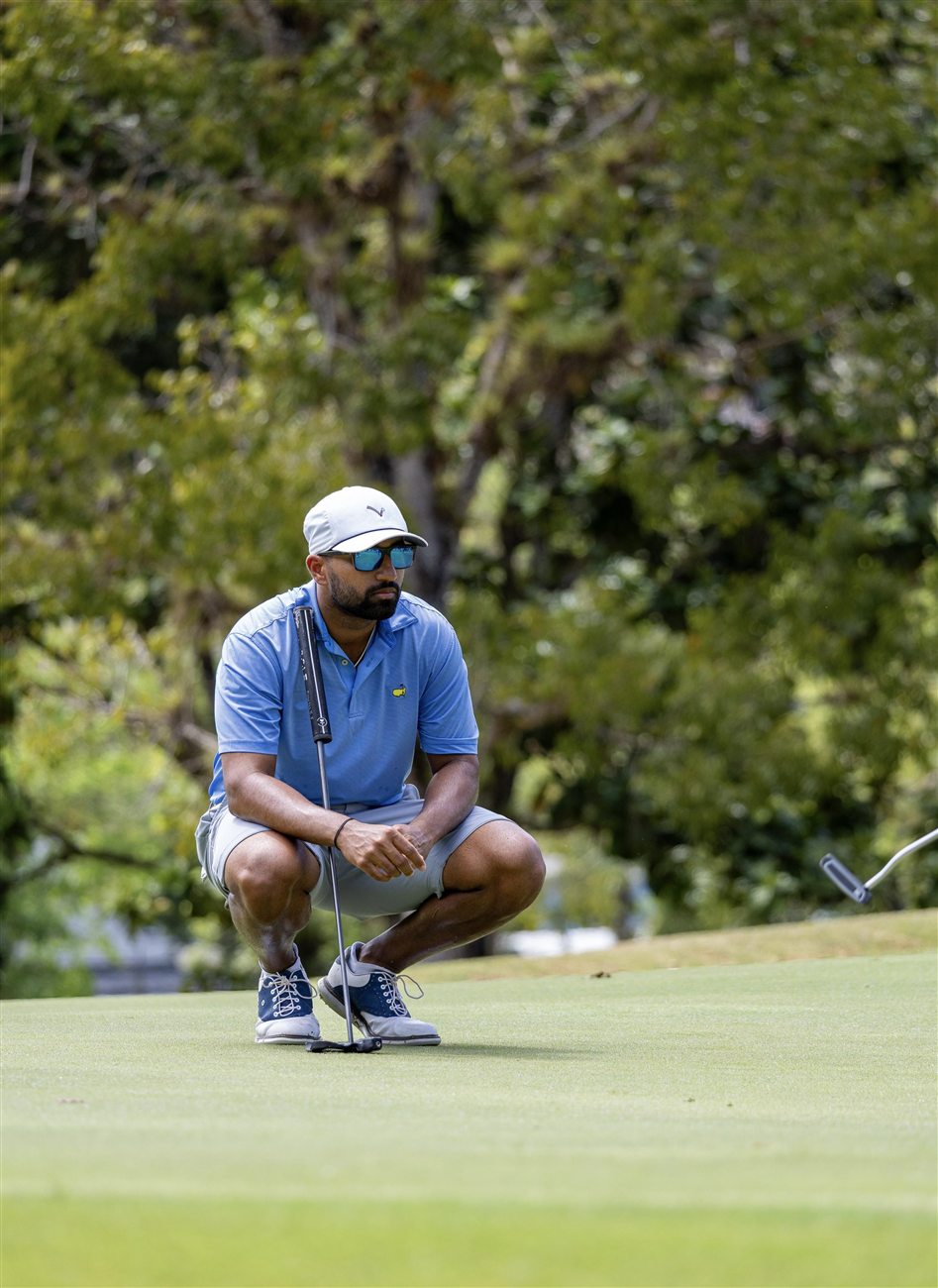 Yadhu Urs reading a putt on the green