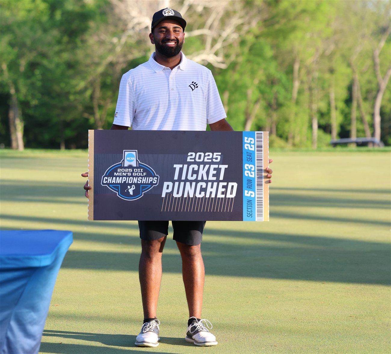 Yadhu Urs holding his 2025 NCAA Division II Men's Golf Championships qualifying ticket